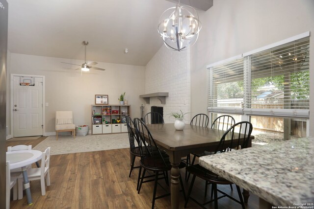 6203 Callen Gln, San Antonio, TX 78233 - dining space featuring high vaulted ceiling, hardwood / wood-style floors, a brick fireplace, a chandelier, and a ceiling fan