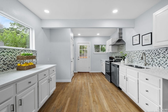 131 New Hvn, San Antonio, TX 78209 - kitchen featuring wall chimney exhaust hood, a sink, stainless steel appliances, tasteful backsplash, and white cabinets