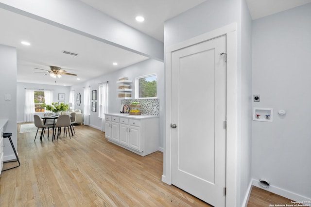 131 New Hvn, San Antonio, TX 78209 - kitchen with a ceiling fan, white cabinetry, light wood-type flooring, baseboards, and light countertops