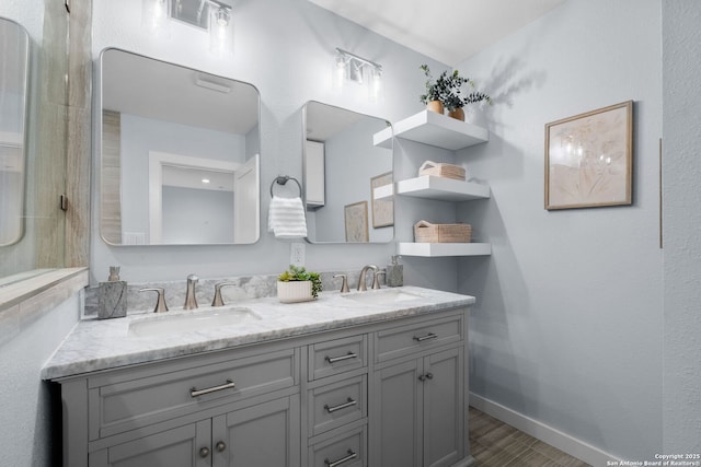 131 New Hvn, San Antonio, TX 78209 - full bath featuring double vanity, baseboards, and wood finished floors