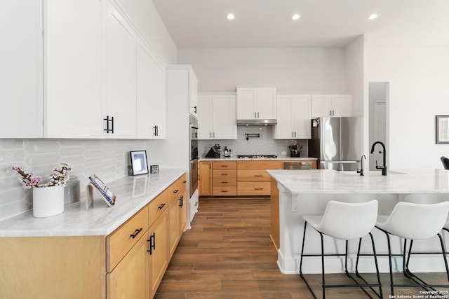 1512 Aubrey Pt, San Antonio, TX 78260 - kitchen with stainless steel appliances, under cabinet range hood, a kitchen breakfast bar, dark wood finished floors, and recessed lighting