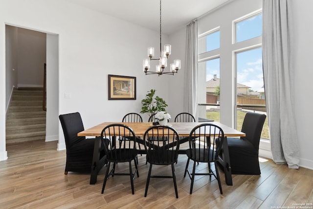 1512 Aubrey Pt, San Antonio, TX 78260 - dining area with a chandelier, baseboards, light wood finished floors, and stairs