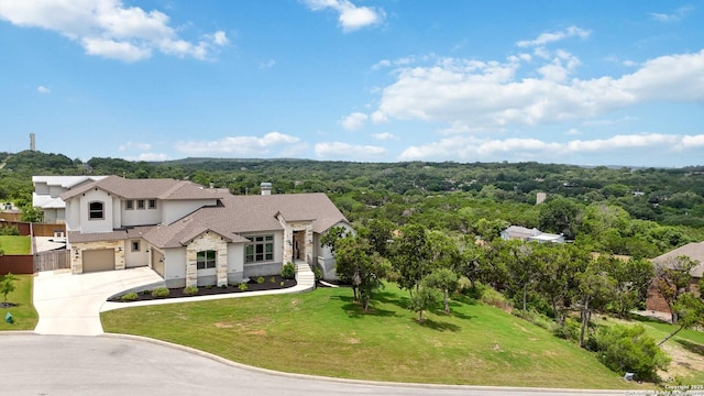 1512 Aubrey Pt, San Antonio, TX 78260 - view of front of house featuring a garage, driveway, stucco siding, stone siding, and a view of trees