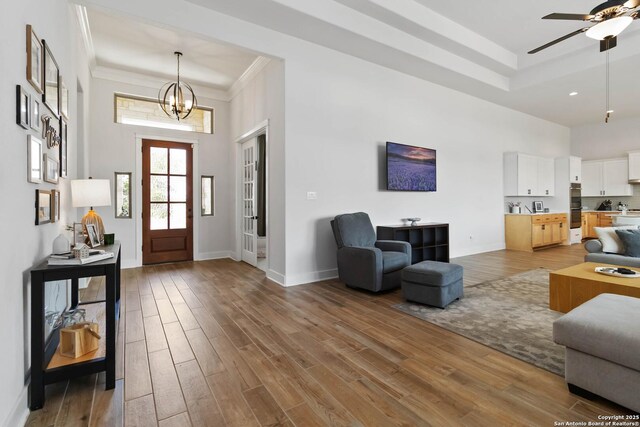 1512 Aubrey Pt, San Antonio, TX 78260 - foyer entrance featuring a tray ceiling, wood finished floors, ceiling fan, baseboards, and a towering ceiling