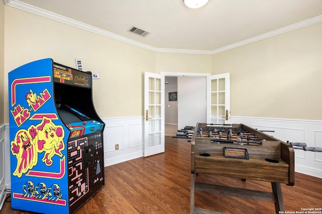 9106 Thomas York, San Antonio, TX 78251 - rec room featuring french doors, ornamental molding, a wainscoted wall, wood finished floors, and a decorative wall