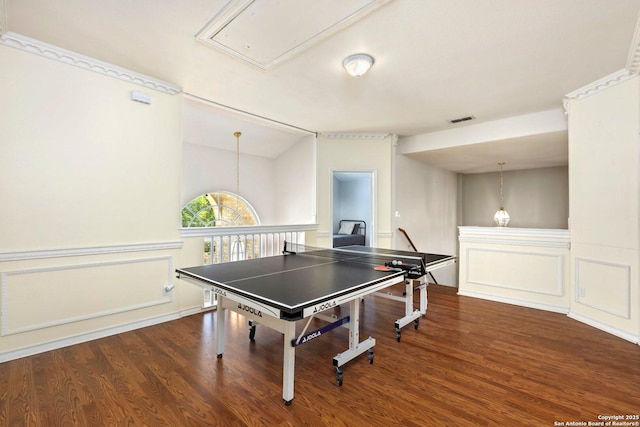 9106 Thomas York, San Antonio, TX 78251 - rec room with attic access, a decorative wall, wood finished floors, and a wainscoted wall