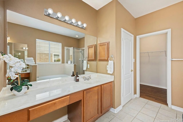 9106 Thomas York, San Antonio, TX 78251 - bathroom with tile patterned flooring, a shower stall, a garden tub, vanity, and a walk in closet
