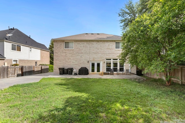 9106 Thomas York, San Antonio, TX 78251 - back of property featuring french doors, a patio area, a fenced backyard, and brick siding