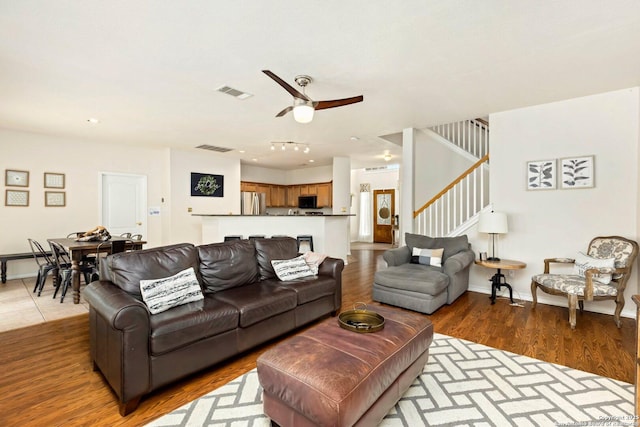 9106 Thomas York, San Antonio, TX 78251 - living room with stairway, ceiling fan, and wood finished floors