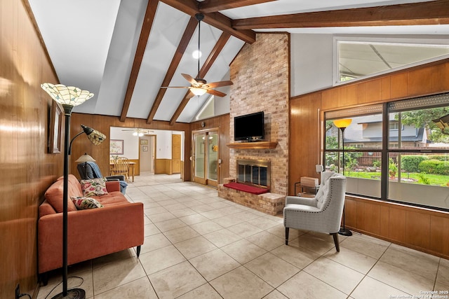 9219 George Kyle St, San Antonio, TX 78240 - living area with wood walls, beamed ceiling, a ceiling fan, tile patterned floors, and a fireplace