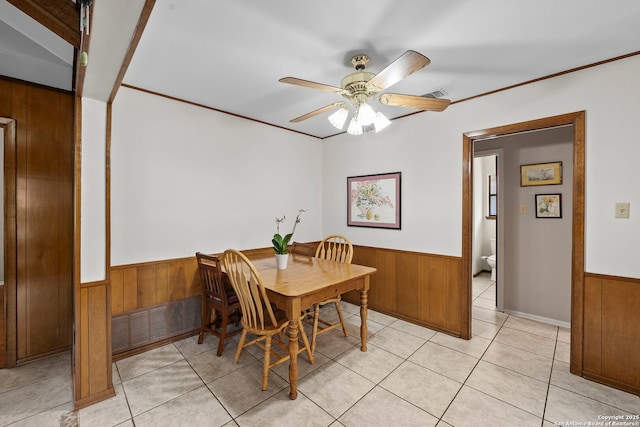 9219 George Kyle St, San Antonio, TX 78240 - dining room with wainscoting, wood walls, ceiling fan, and light tile patterned flooring