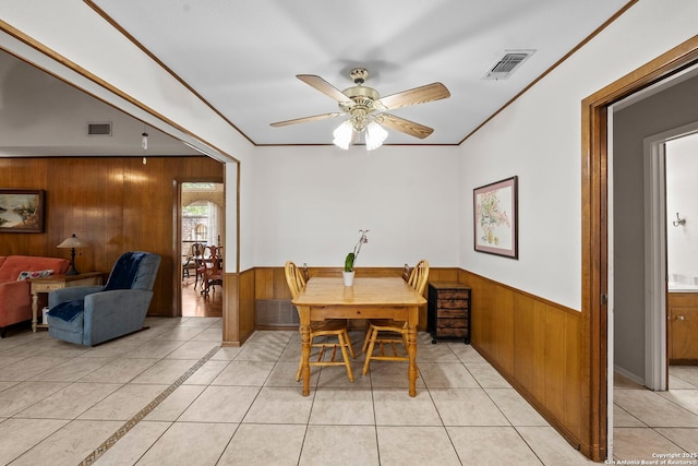 9219 George Kyle St, San Antonio, TX 78240 - dining room featuring wooden walls, wainscoting, a ceiling fan, light tile patterned floors, and ornamental molding