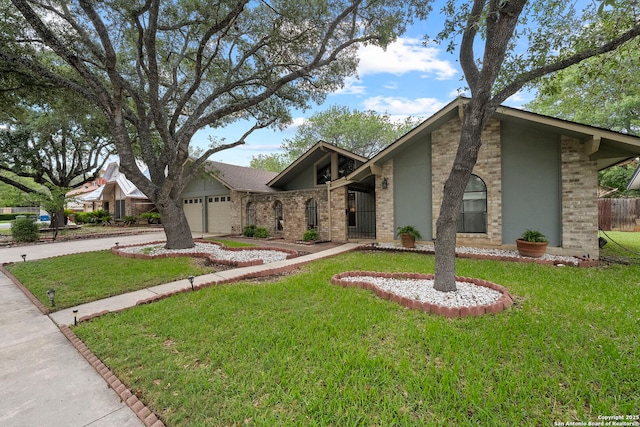 9219 George Kyle St, San Antonio, TX 78240 - mid-century modern home with brick siding, driveway, a front yard, and an attached garage