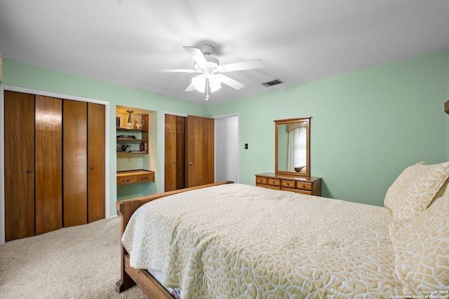 9219 George Kyle St, San Antonio, TX 78240 - carpeted bedroom featuring two closets and ceiling fan