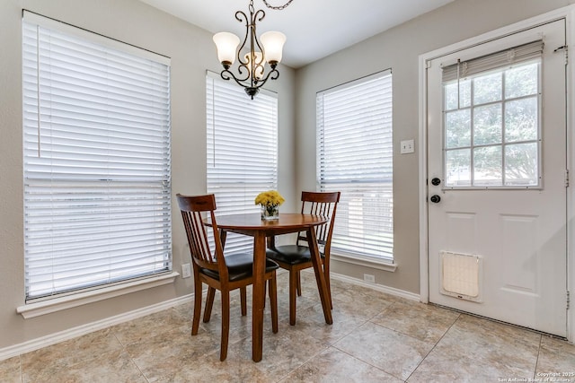 18039 Shady Knl, San Antonio, TX 78258 - dining space with a chandelier, plenty of natural light, baseboards, and light tile patterned floors