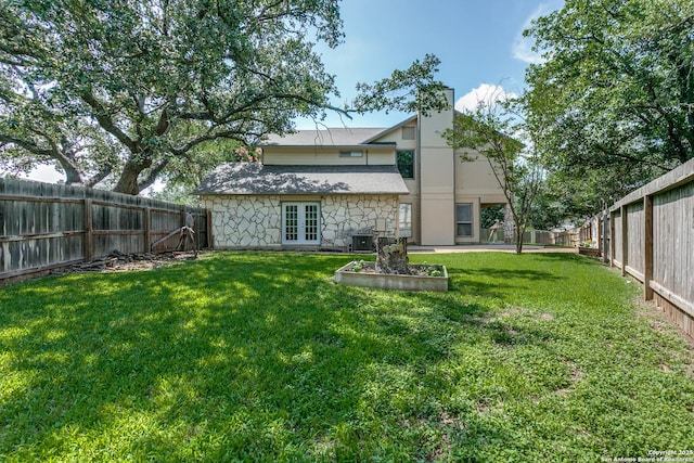 18039 Shady Knl, San Antonio, TX 78258 - rear view of house featuring french doors, cooling unit, and stone siding
