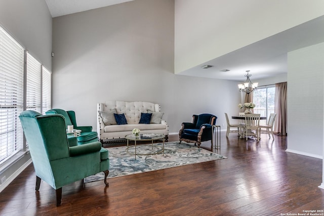 18039 Shady Knl, San Antonio, TX 78258 - living room featuring a chandelier, wood finished floors, baseboards, and a high ceiling