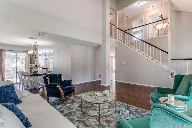 18039 Shady Knl, San Antonio, TX 78258 - living room featuring a chandelier, wood finished floors, baseboards, stairway, and a high ceiling