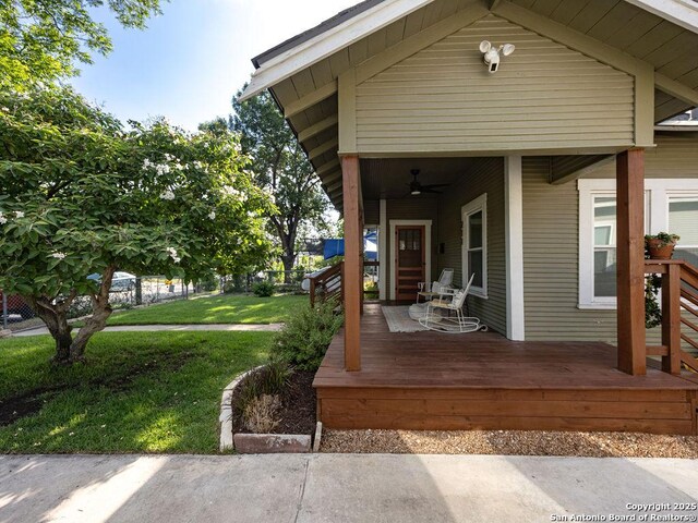 211 W High Ave, San Antonio, TX 78210 - wooden terrace with a ceiling fan and a lawn