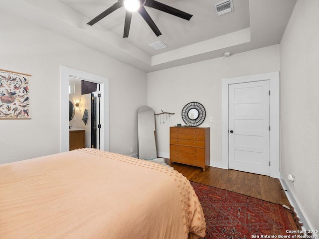 211 W High Ave, San Antonio, TX 78210 - bedroom featuring wood finished floors, a tray ceiling, ensuite bath, and baseboards