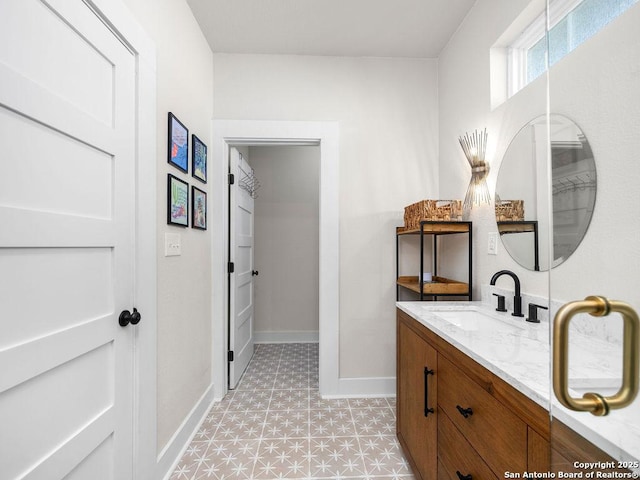 211 W High Ave, San Antonio, TX 78210 - bathroom featuring vanity, baseboards, and tile patterned floors