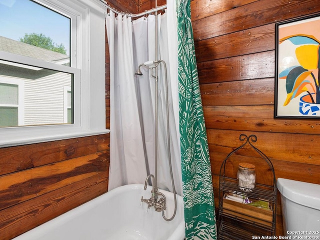 211 W High Ave, San Antonio, TX 78210 - full bath with a freestanding tub, toilet, a shower with shower curtain, and wooden walls