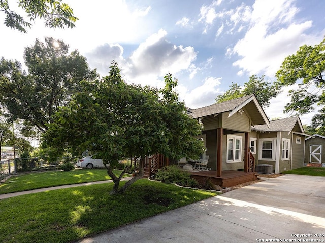 211 W High Ave, San Antonio, TX 78210 - view of front of property with central air condition unit, roof with shingles, and covered porch