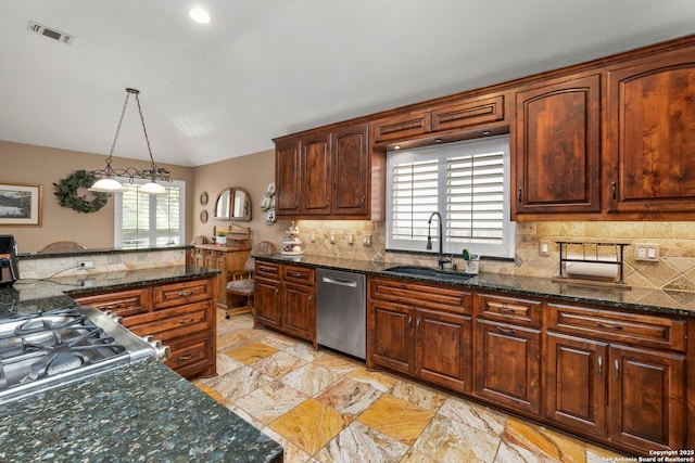 8826 Lost Bnd, San Antonio, TX 78240 - kitchen with stainless steel appliances, a sink, tasteful backsplash, decorative light fixtures, and dark stone countertops