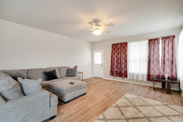 125 Wright Cv, Cibolo, TX 78108 - living area featuring a ceiling fan, baseboards, and light wood-style floors