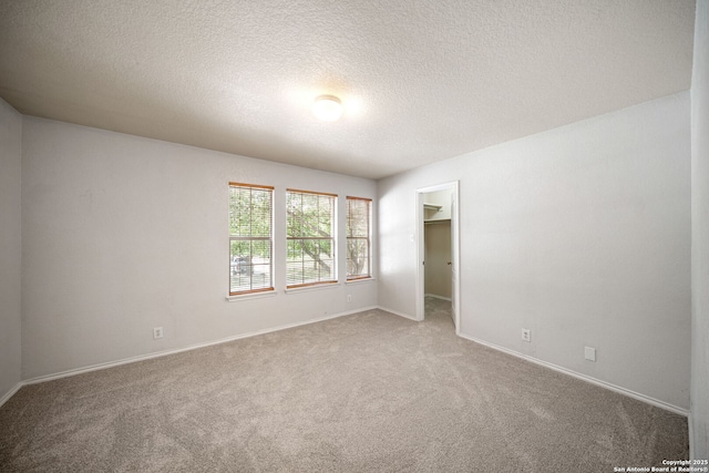 13214 Solar Crst, San Antonio, TX 78245 - empty room featuring carpet, a textured ceiling, and baseboards
