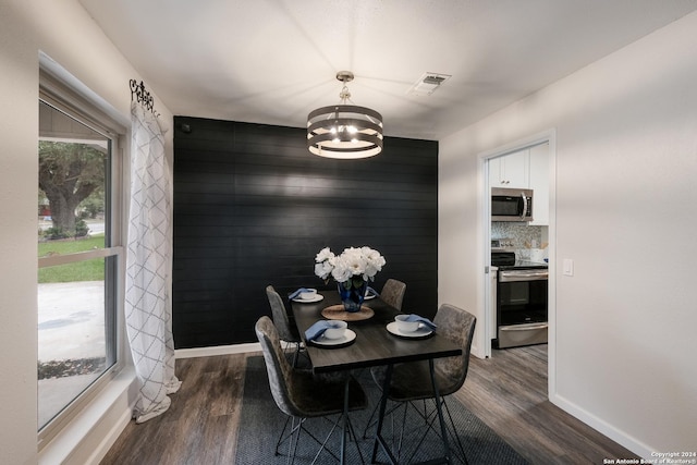 9723 Five Forks St, San Antonio, TX 78245 - dining area featuring a chandelier, dark wood-type flooring, and baseboards