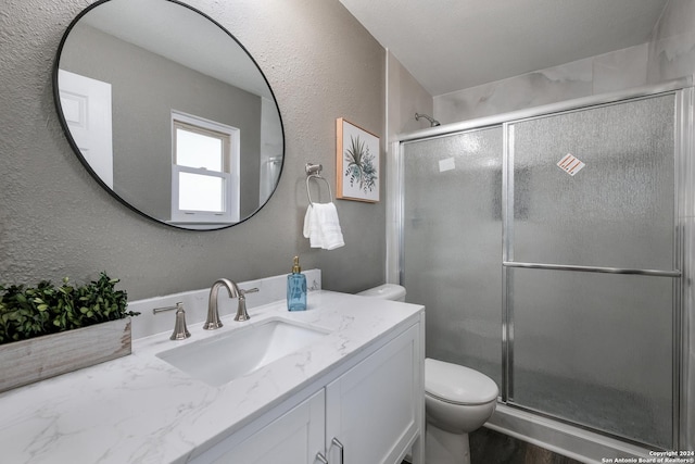 9723 Five Forks St, San Antonio, TX 78245 - full bath with toilet, vanity, a textured wall, and a stall shower