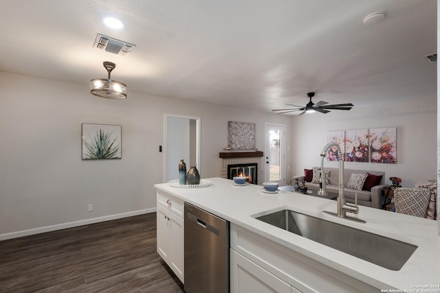 9723 Five Forks St, San Antonio, TX 78245 - kitchen with stainless steel dishwasher, a sink, open floor plan, white cabinets, and light countertops