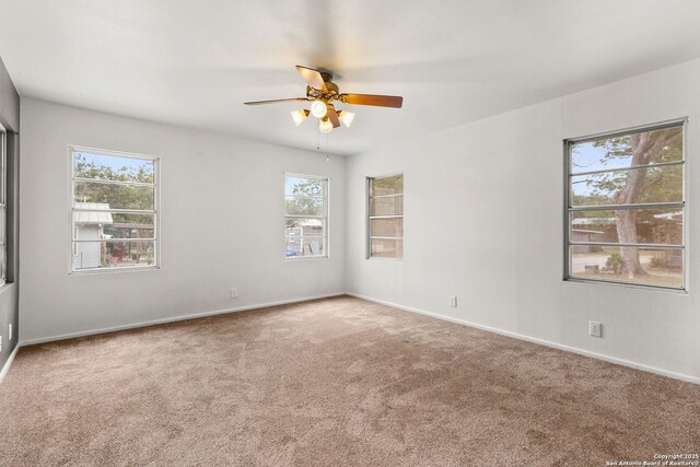 571 Houston, New Braunfels, TX 78130 - empty room featuring carpet floors, ceiling fan, and plenty of natural light