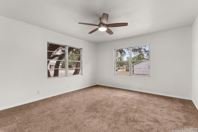 571 Houston, New Braunfels, TX 78130 - unfurnished room with carpet floors, healthy amount of natural light, a ceiling fan, and baseboards