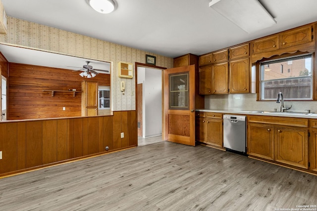 571 Houston, New Braunfels, TX 78130 - kitchen with dishwasher, a sink, wallpapered walls, brown cabinets, and light countertops