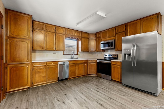 571 Houston, New Braunfels, TX 78130 - kitchen featuring appliances with stainless steel finishes, brown cabinetry, and light countertops