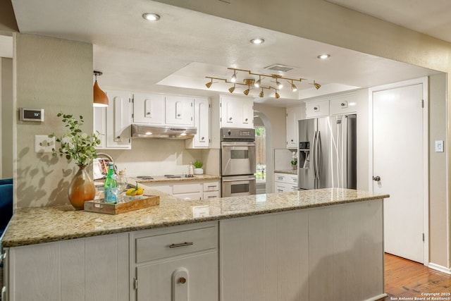 308 Sagecrest, Hollywood Park, TX 78232 - kitchen with stainless steel appliances, a peninsula, under cabinet range hood, a raised ceiling, and light wood-style flooring