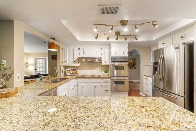 308 Sagecrest, Hollywood Park, TX 78232 - kitchen featuring stainless steel appliances, a sink, arched walkways, under cabinet range hood, and white cabinetry