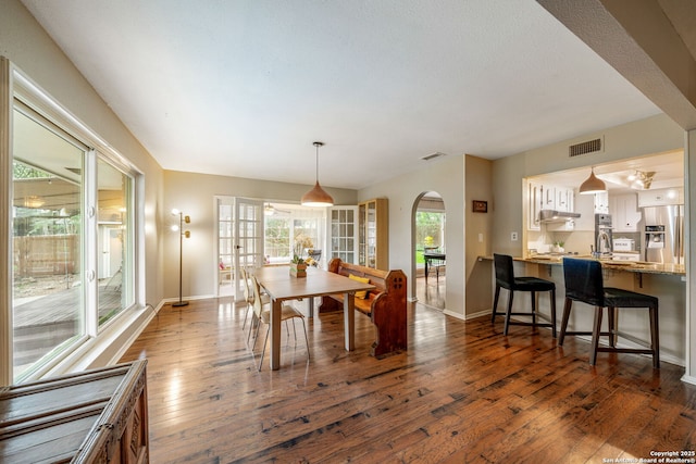 308 Sagecrest, Hollywood Park, TX 78232 - dining space featuring dark wood finished floors, baseboards, and arched walkways