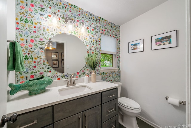 308 Sagecrest, Hollywood Park, TX 78232 - half bathroom with wallpapered walls, vanity, toilet, and baseboards