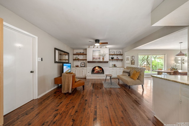 308 Sagecrest, Hollywood Park, TX 78232 - living area featuring dark wood-type flooring, a ceiling fan, and a fireplace