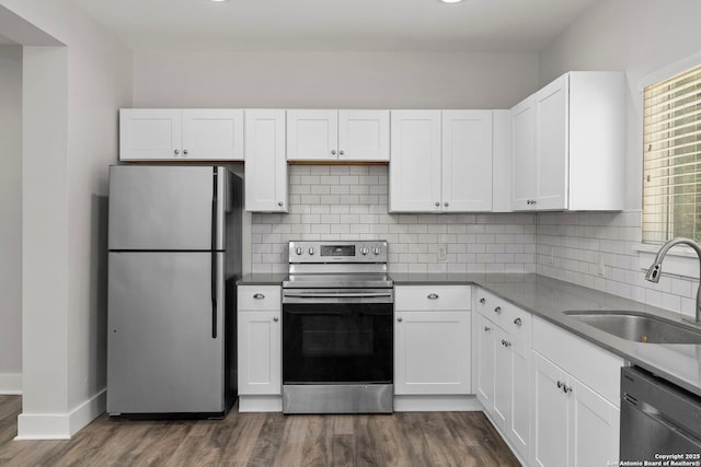 129 Odell, San Antonio, TX 78212 - kitchen featuring stainless steel appliances, a sink, dark wood-style flooring, and white cabinetry
