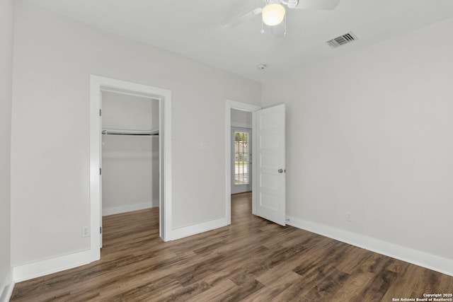 129 Odell, San Antonio, TX 78212 - unfurnished bedroom with wood finished floors, a closet, baseboards, a walk in closet, and ceiling fan