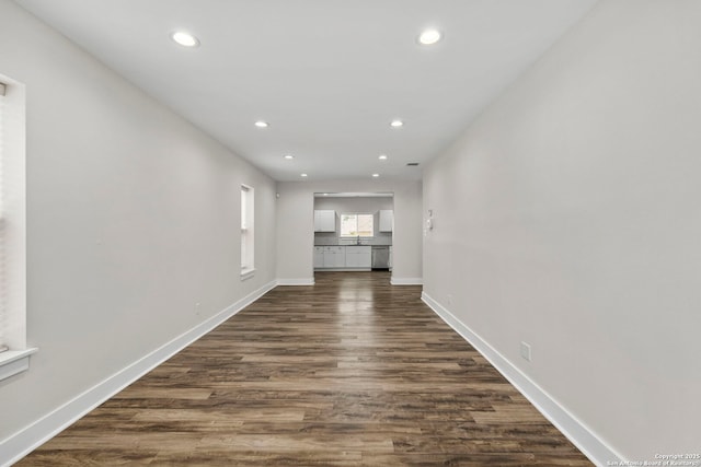 129 Odell, San Antonio, TX 78212 - unfurnished living room with recessed lighting, dark wood-style flooring, baseboards, and a sink