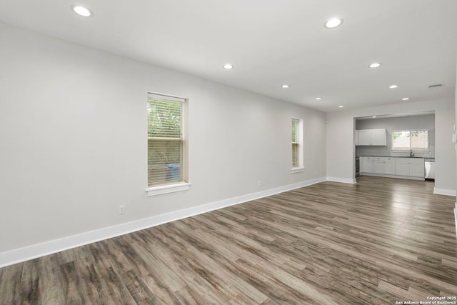 129 Odell, San Antonio, TX 78212 - unfurnished living room with recessed lighting, dark wood-type flooring, and baseboards