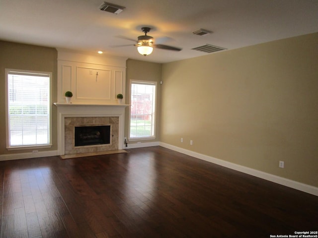 5014 Ashton Audrey, San Antonio, TX 78249 - unfurnished living room with baseboards, dark wood-type flooring, ceiling fan, and a fireplace