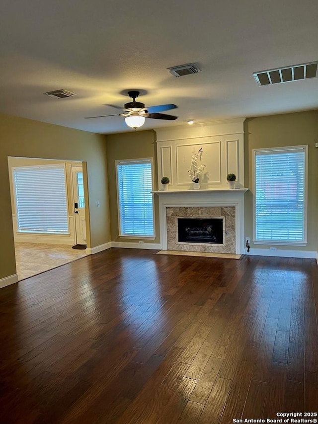 5014 Ashton Audrey, San Antonio, TX 78249 - unfurnished living room with a premium fireplace, ceiling fan, dark wood finished floors, and baseboards