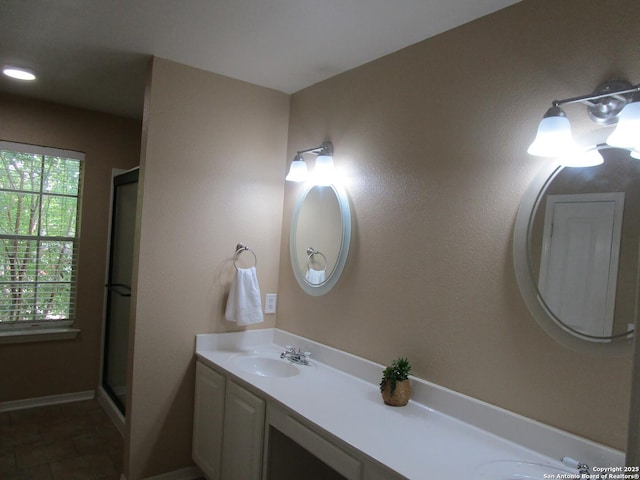 5014 Ashton Audrey, San Antonio, TX 78249 - bathroom featuring double vanity, a shower stall, and baseboards