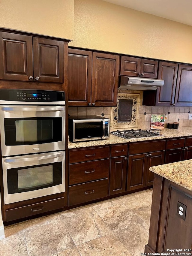 5014 Ashton Audrey, San Antonio, TX 78249 - kitchen featuring stainless steel appliances, tasteful backsplash, under cabinet range hood, and dark brown cabinetry